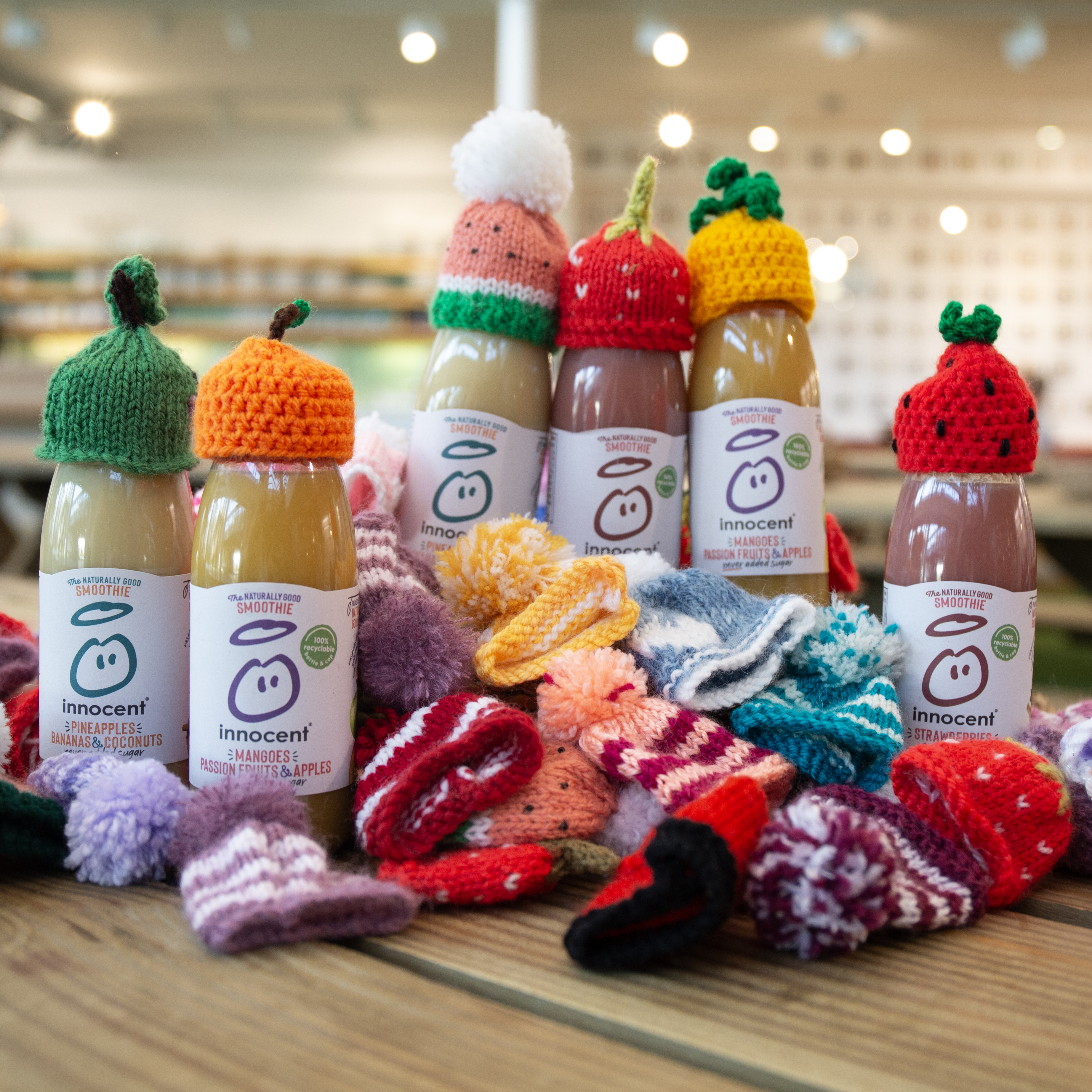 Here's a group of smoothie bottles with hats on them. 